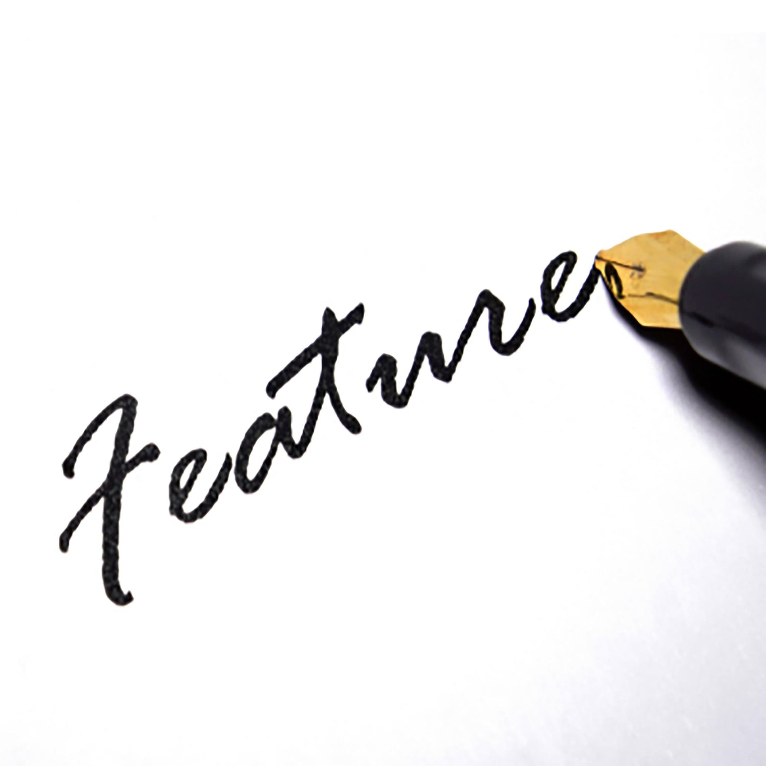 Fountain pen writing the word feature in ink.