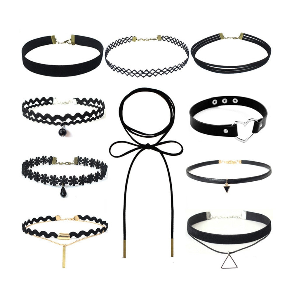 A collection of ten black chokers with varying designs, including lace, pearls, bows, and geometric pendants, arranged on a white background.