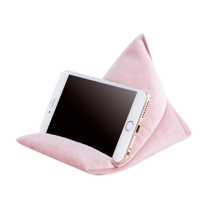 A pink, triangular phone stand holds a smartphone upright, providing a stylish and ergonomic way to view the screen hands-free.