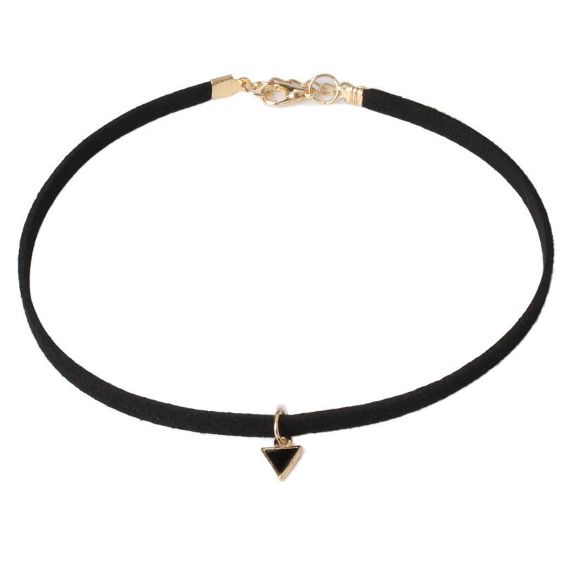 A simple black choker with a gold clasp and a small black triangle pendant hangs at the center. The design is minimalist and elegant.