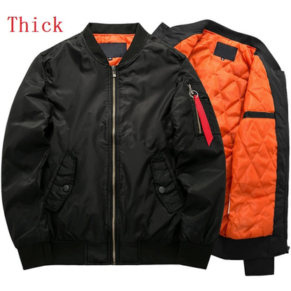Black bomber jacket with a vibrant orange quilted lining and "Thick" label text. Features a zipper, pockets, and a red tag. Warm and stylish.