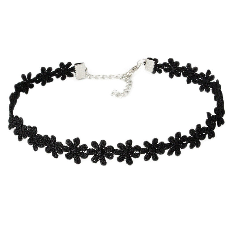 Black choker necklace with lace flower pattern. Silver clasp and adjustable chain. Elegant, delicate design on a plain white background.