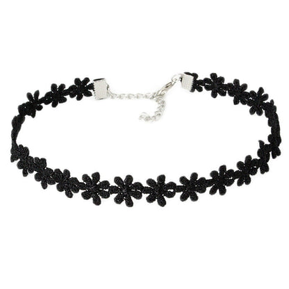 Black choker necklace with lace flower pattern. Silver clasp and adjustable chain. Elegant, delicate design on a plain white background.