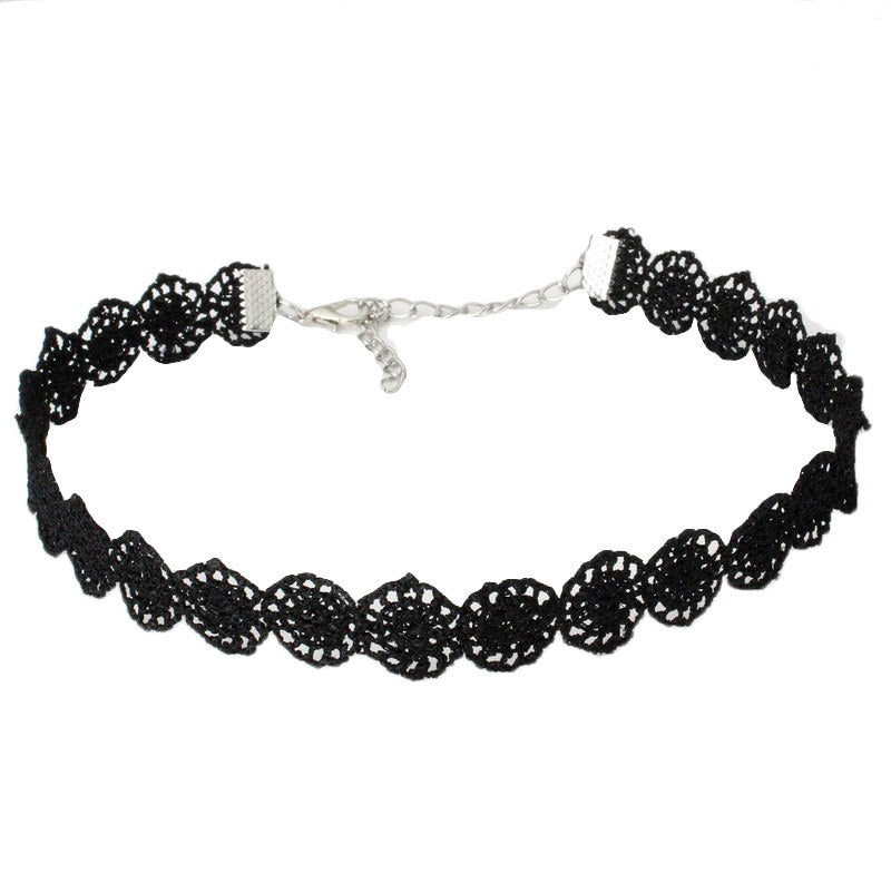 Black lace choker with intricate floral design and silver chain clasp, set against a white background, conveying elegance and a vintage feel.