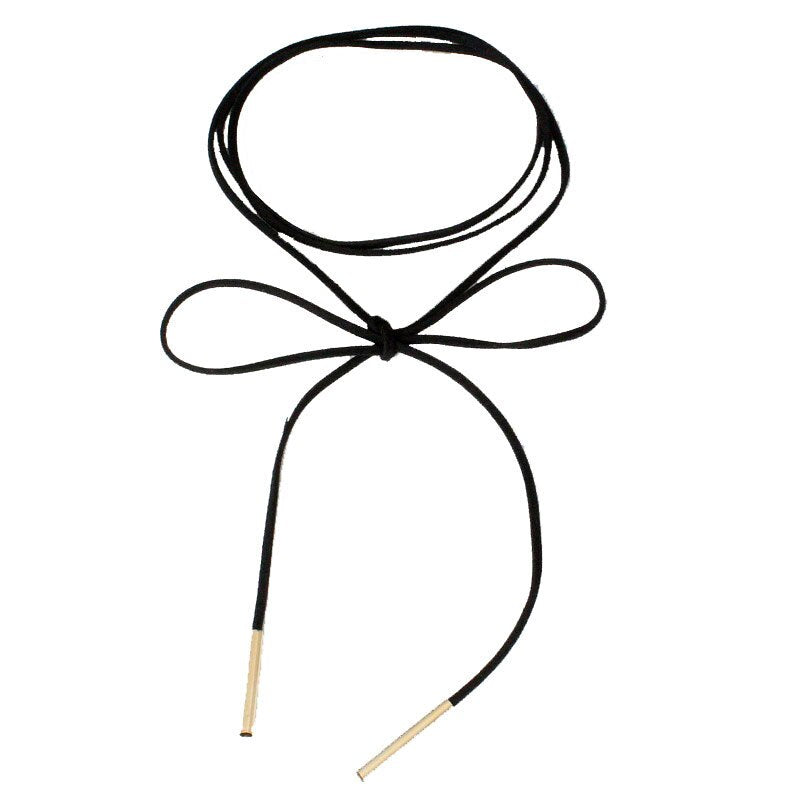 Black suede choker necklace with a bow in the center and gold metal tips at the end. The design is simple and elegant, conveying a chic tone.