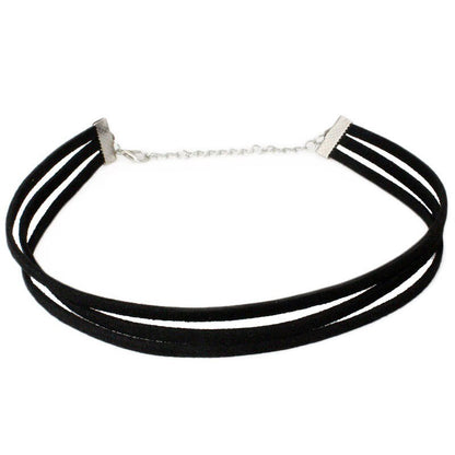 Black velvet choker featuring three strands and a silver adjustable chain clasp. The look is minimalist and elegant, conveying a modern, stylish tone.