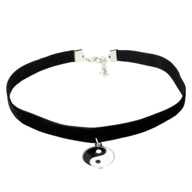 Black velvet choker necklace with a silver Yin-Yang pendant, featuring an adjustable clasp. The design conveys balance and elegance.