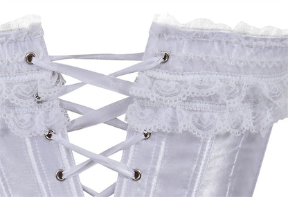 Close-up of a white satin corset with intricate lace trim and crisscrossed white lacing through silver eyelets, conveying elegance and vintage style.