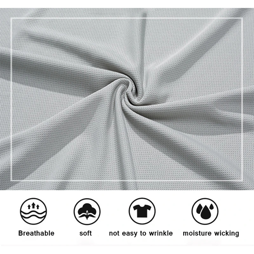 Close-up of light gray fabric, highlighting its breathable, soft, wrinkle-resistant, and moisture-wicking qualities with labeled icons.