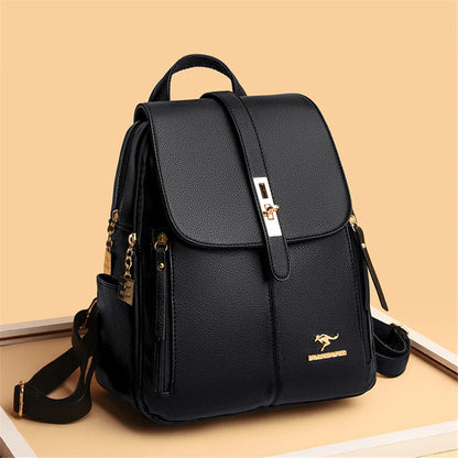 Elegant black backpack with gold accents, featuring a flap closure and multiple pockets, set against a soft beige background.