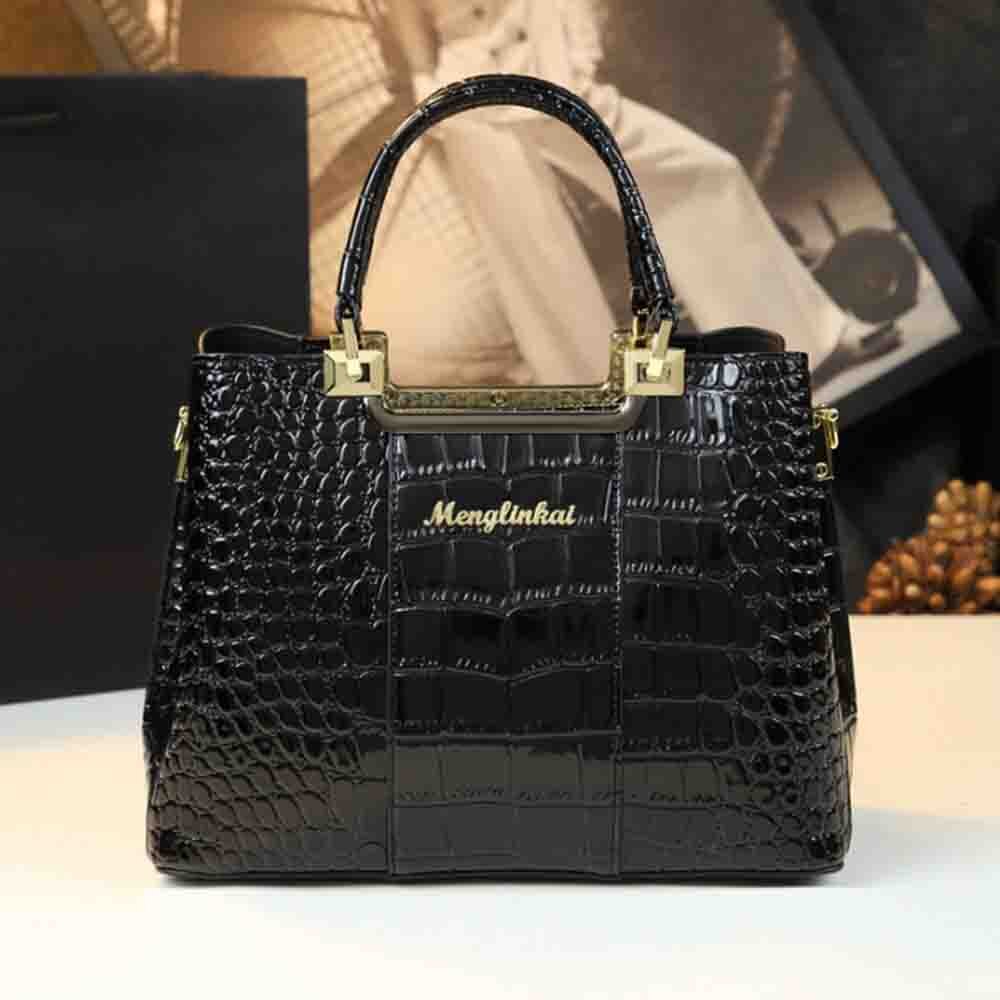 Elegant black crocodile-patterned handbag with gold accents and the brand name "Menglinkai" displayed prominently on the front.