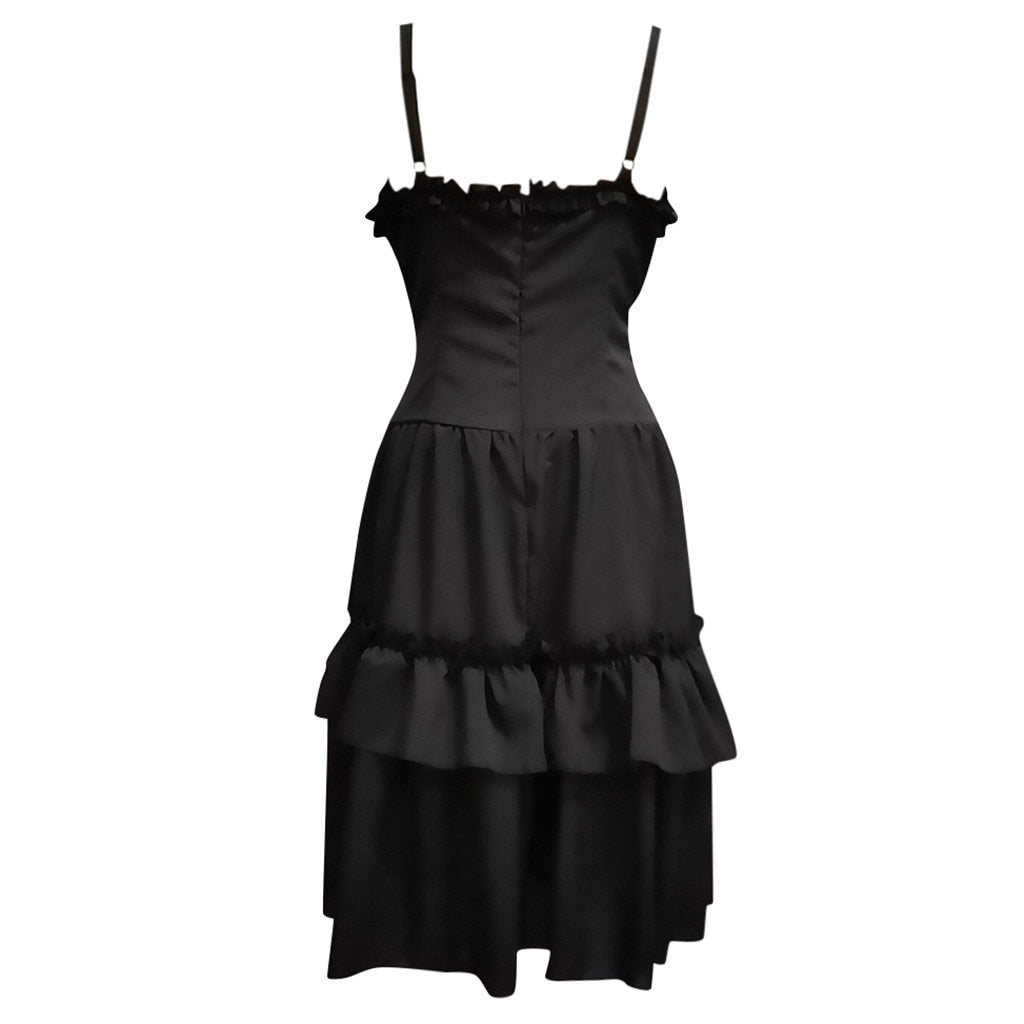 Elegant black dress with thin straps and a ruffled neckline. The fitted bodice flows into a two-tiered layered skirt, conveying a classic, sophisticated tone.