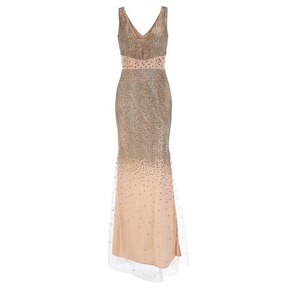 Elegant long gown with a deep V-neckline, shimmering with silver sequins that fade into a smooth beige at the hem, conveying a glamorous tone.