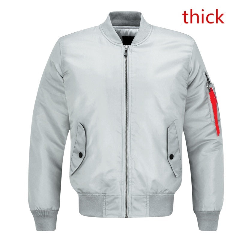 Gray bomber jacket with front zipper and two side pockets, featuring a red zipper detail on the sleeve. The word "thick" appears in red text.