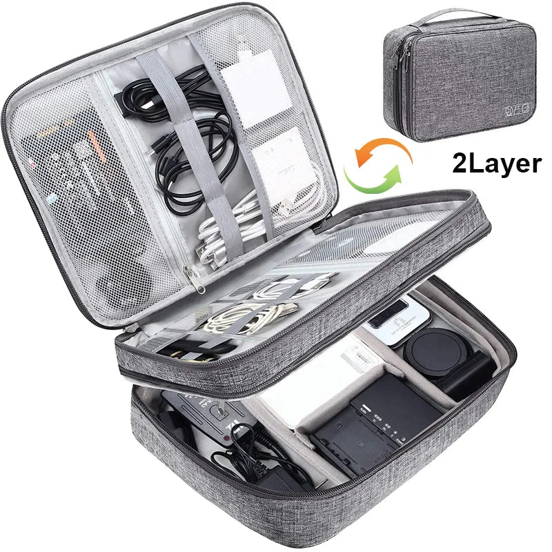 Gray travel electronics organizer case with two layers, equipped with compartments for cables, chargers, and devices.