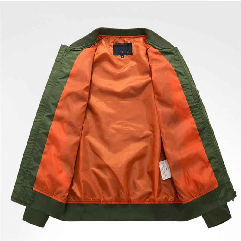 Green bomber jacket with open bright orange lining, displayed on a light gray background. The vibrant contrast suggests a stylish, modern design.