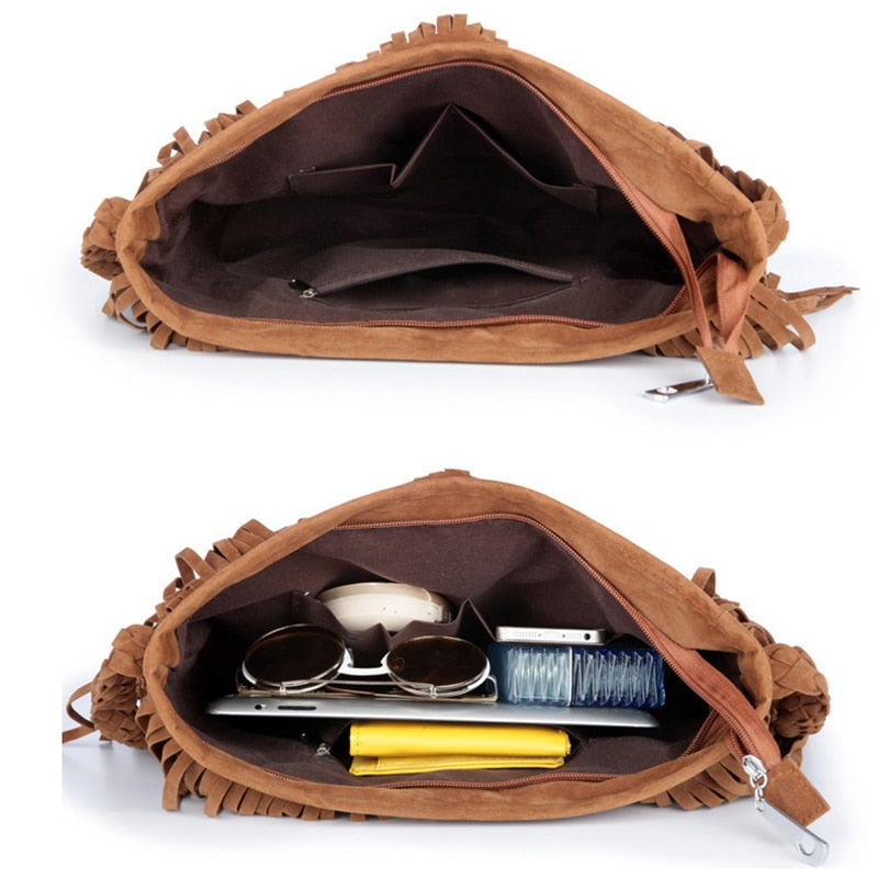 Open brown suede bag showcasing its interior, containing sunglasses, a tablet, a yellow wallet, and various small items.