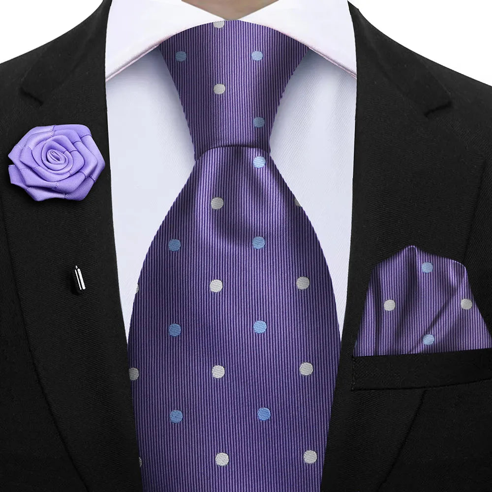 Purple polka dot tie with matching pocket square and lapel flower on a suit.