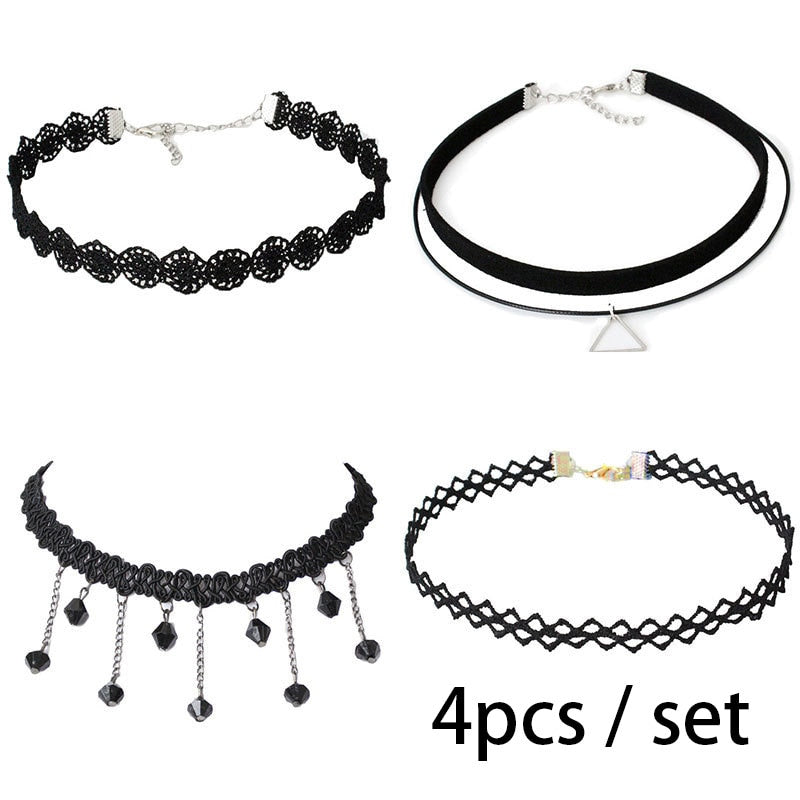 Set of four black chokers with varying designs: lace, minimalist with triangle pendant, fringe with beads, and a lattice pattern. Stylish and trendy.