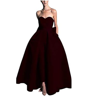 Strapless dark burgundy ball gown with a fitted bodice and voluminous skirt. The dress exudes elegance and sophistication, perfect for formal events.