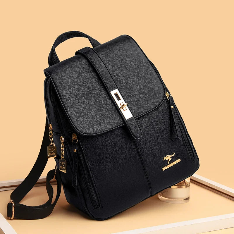 Stylish black backpack with gold accents, featuring a flap closure and zippers, set against a warm beige background.