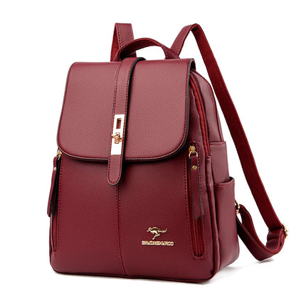 Stylish burgundy backpack with a sleek design, featuring a flap closure, gold accents, and multiple pockets for convenience.
