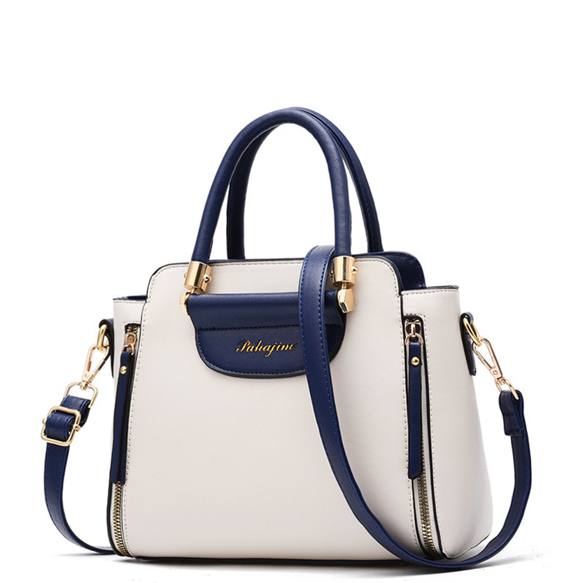 Stylish white handbag with navy accents, dual handles, a detachable shoulder strap, and gold hardware detailing.