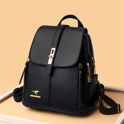 Stylish black backpack with gold accents, featuring a flap closure and multiple compartments, set against a warm background.