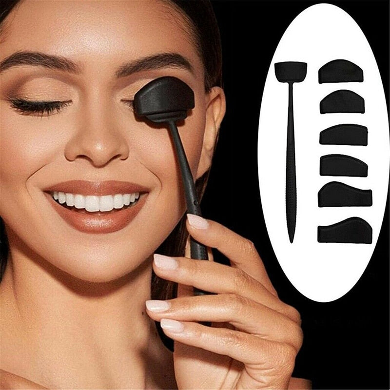 A woman with closed eyes smiles while using a black eyeshadow applicator on her eyelid. Various applicator shapes are shown on the right against a white oval.