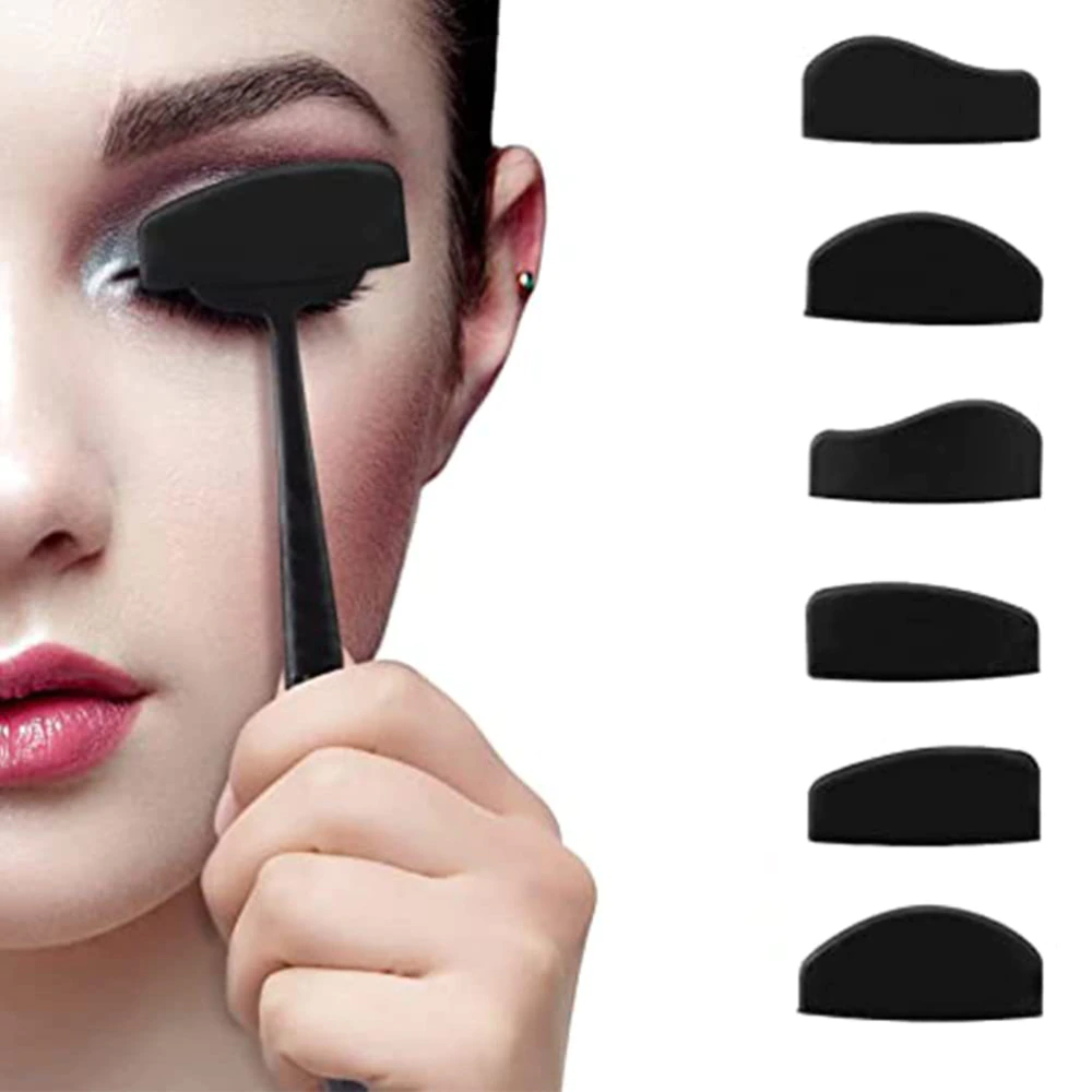 Close-up of a woman using a black makeup tool on their closed eyelid, with five different-shaped black eyeshadow stencils displayed vertically on the right.