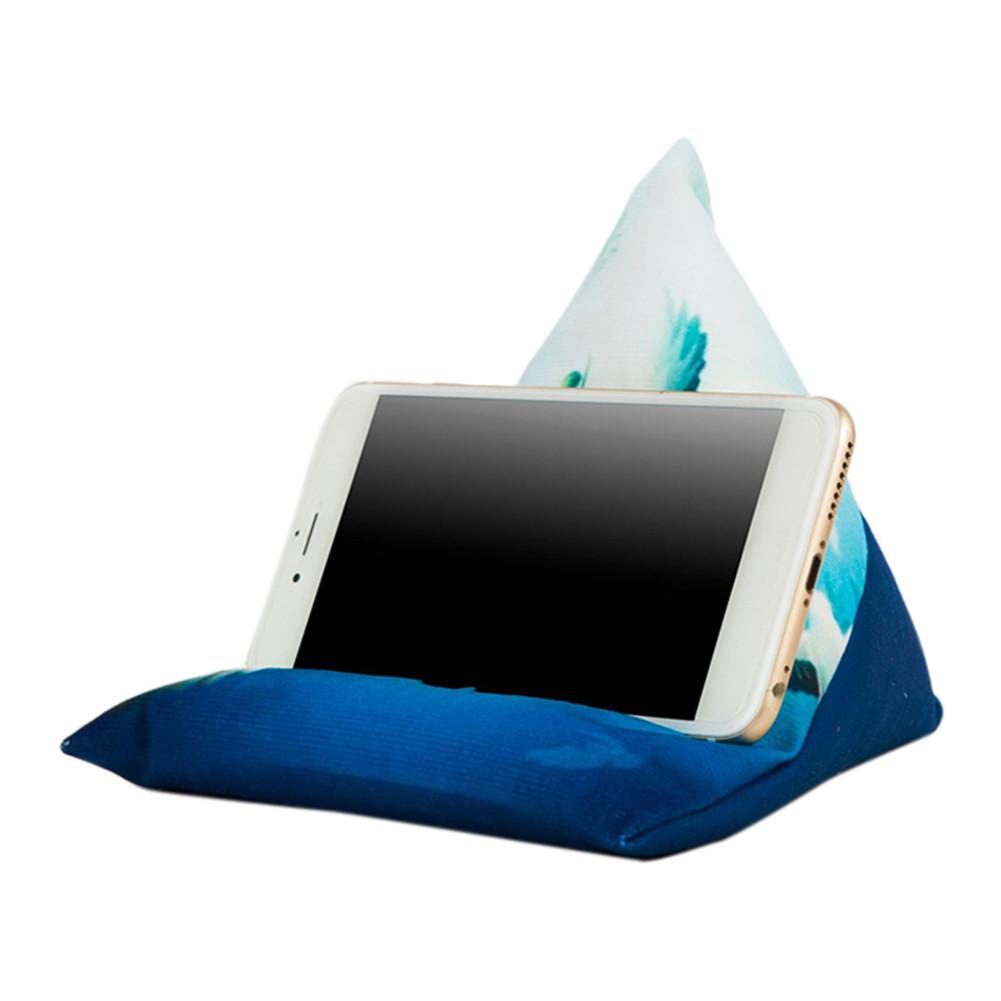 A smartphone resting on a colorful fabric phone stand shaped like a pyramid, designed for hands-free viewing.