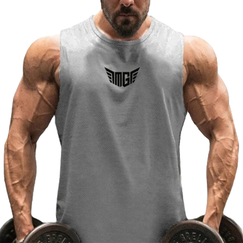 A muscular man in a gray sleeveless shirt holds dumbbells, showcasing well-defined arms and a focused expression.