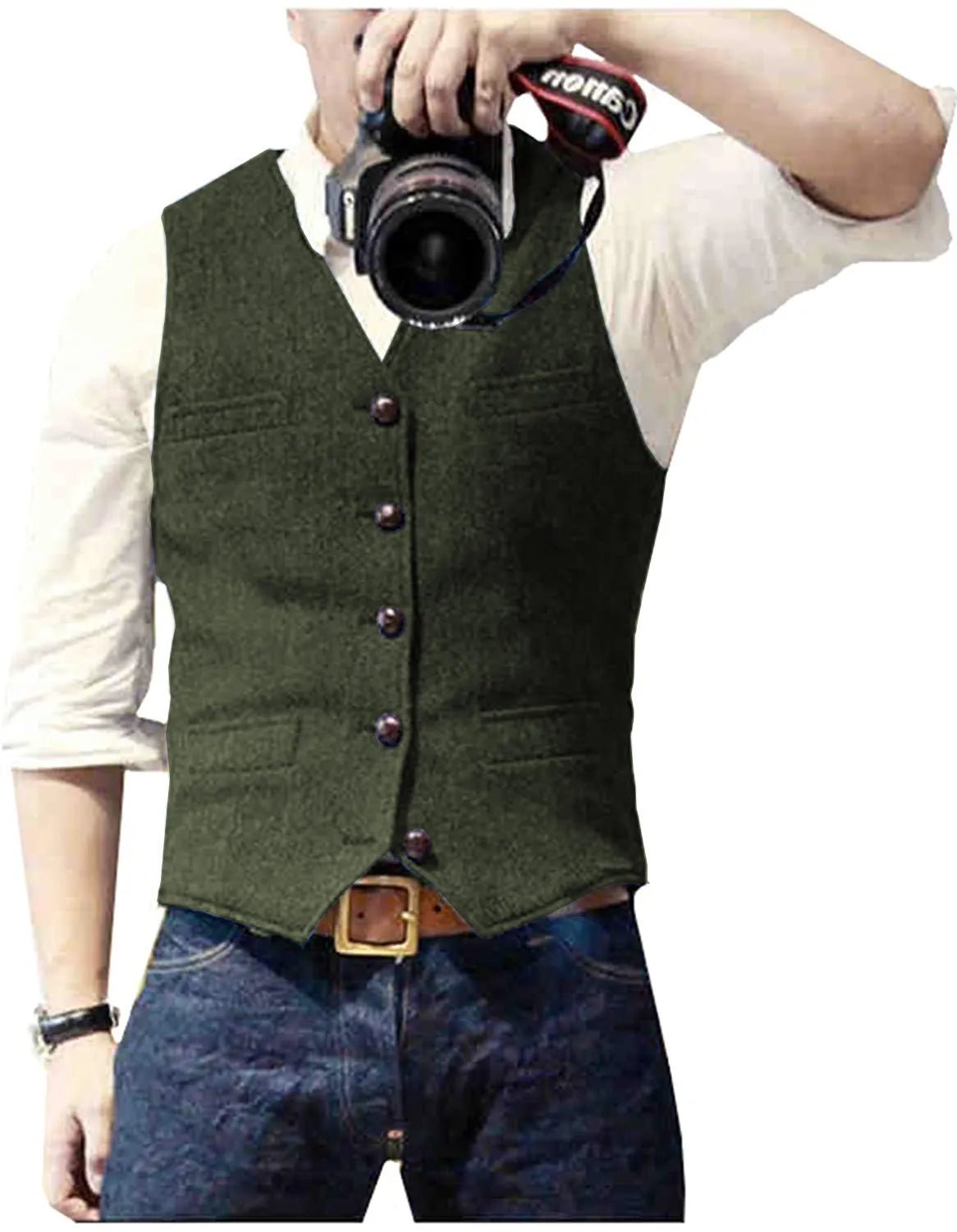 A man wearing a green vest and jeans holds a camera, taking a photograph of himself in a casual setting.
