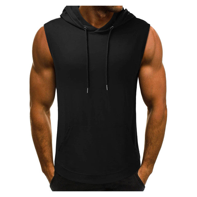 Man wearing a sleeveless black hoodie with a front pocket and drawstrings. His muscular arms are visible, conveying a sporty, casual vibe.