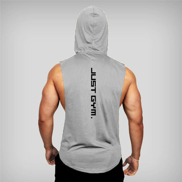 A muscular man wearing a sleeveless gray hoodie from the back, featuring the phrase "JUST GYM." prominently displayed.
