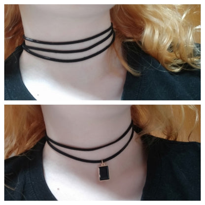 a woman wearing different black choker necklaces. The top is simple with loops, while the bottom has a rectangular pendant.