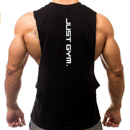 A muscular man wears a black tank top with the phrase "JUST GYM." printed vertically on the back, showcasing his strong physique.