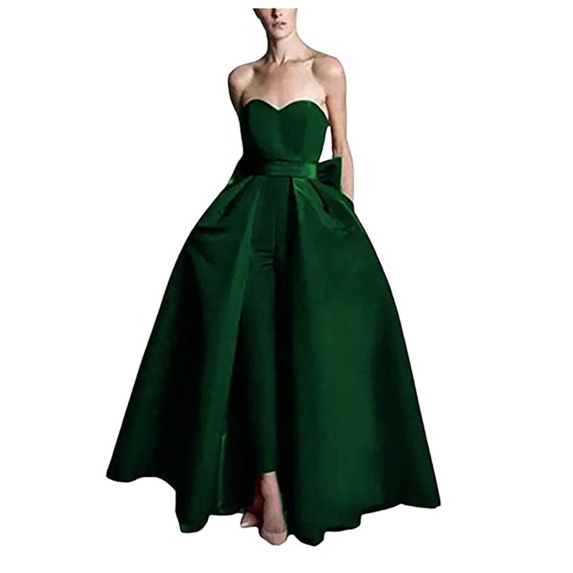 A woman models a strapless, deep green evening gown with a full skirt and cinched waist, creating an elegant and sophisticated look.