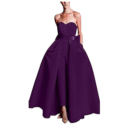 A woman wearing a strapless, deep purple ball gown with a full skirt. The elegant design exudes sophistication and a classic, formal tone.
