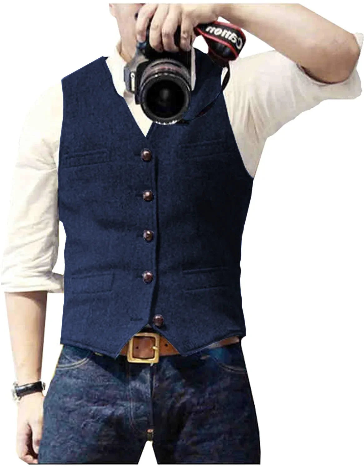 A man wearing a navy blue vest over a white shirt, holding a camera in front of him, poses confidently for a photo.