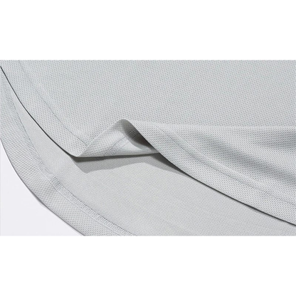 Close-up of a folded, light gray fabric with a textured surface, showcasing its soft drape and clean seam edges.