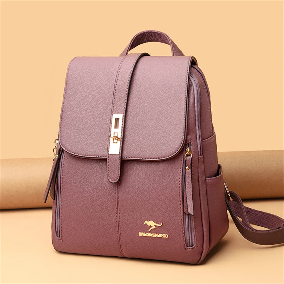 Stylish mauve backpack with a gold accent clasp, featuring a sleek design and side pocket, set against a neutral background.
