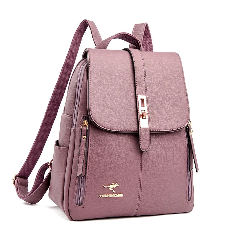 A stylish mauve leather backpack with a flap closure, gold accents, and multiple zippered compartments for organization.