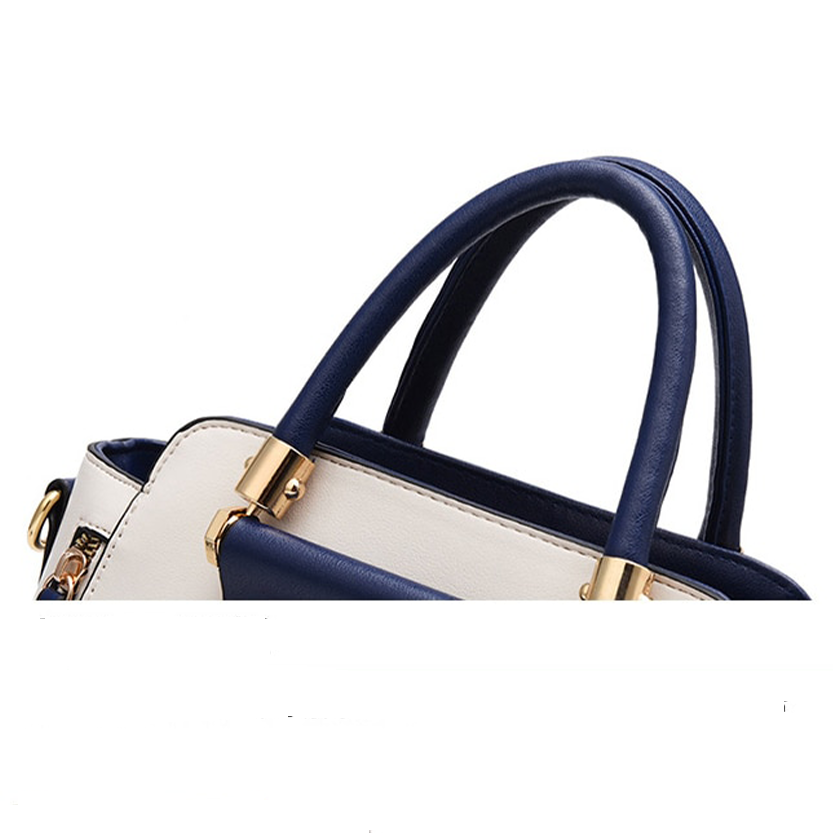 Stylish handbag featuring navy blue and white design with gold hardware accents and rounded handles. Perfect for daily use.