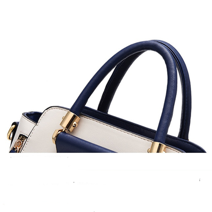 Stylish handbag featuring navy blue and white design with gold hardware accents and rounded handles. Perfect for daily use.
