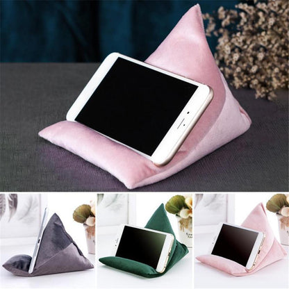 A cozy triangular phone stand in pink, gray, and green, each holding a smartphone at an angle for easy viewing.
