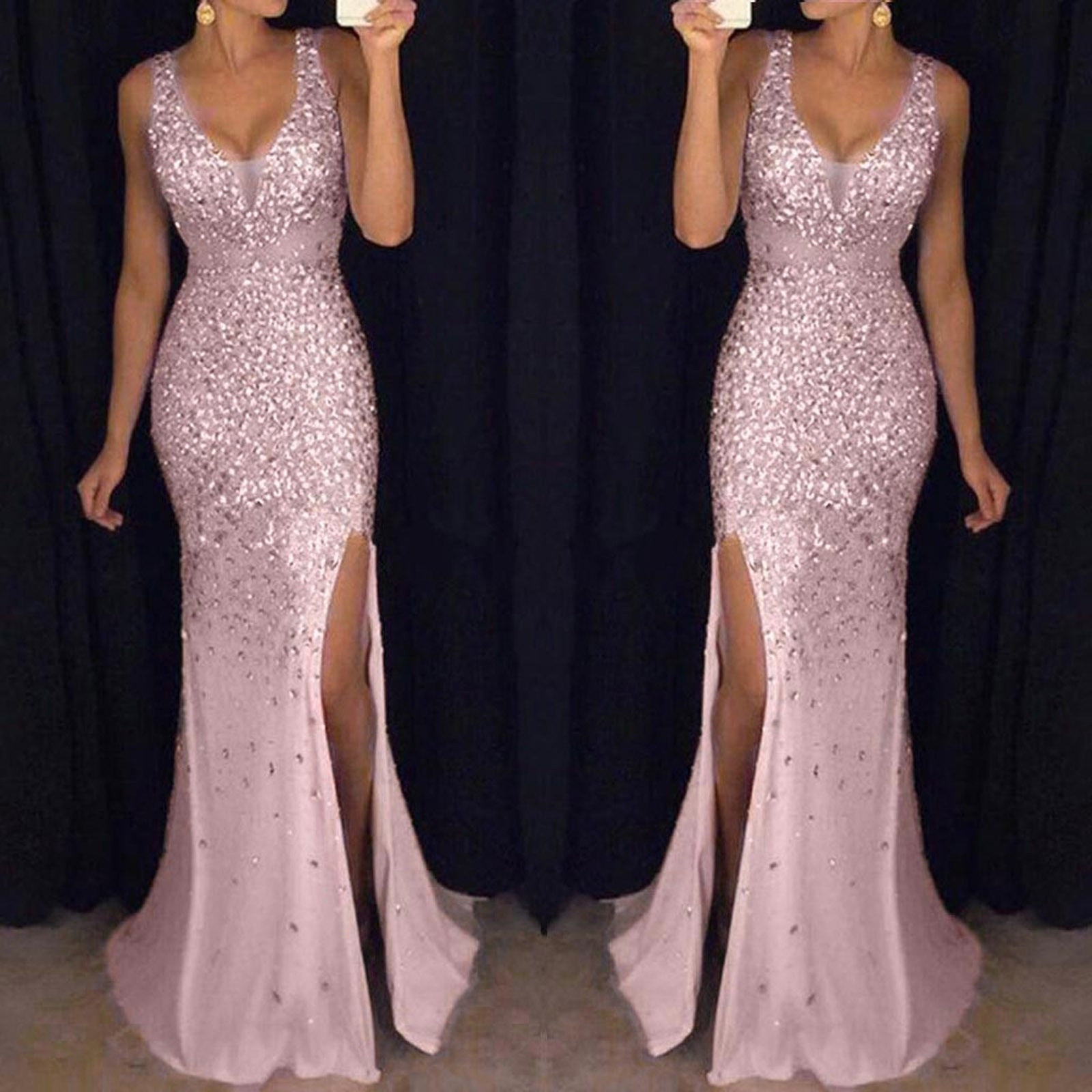 A woman in a shimmering, sleeveless pink gown with a deep v-neck and high slit stands in front of a dark background, conveying elegance and glamour.